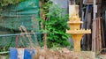 Small Buddhist sanctuary among the heaps of garbage on a city street, a garbage dump near a