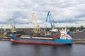 Small bulk carrier ship loading coal Riga