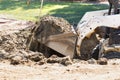 Small Bulldozer Digging Up Dirt and Grass Royalty Free Stock Photo