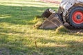 Small Bulldozer Removing Grass From Yard Preparing For Pool Installation