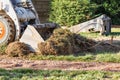 Small Bulldozer Removing Grass From Yard Preparing For Pool