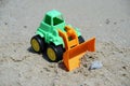 Small bulldozer toy. Bulldozer toy on a beach sand. Royalty Free Stock Photo