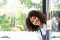 Small business african female owner smiling while turning sign for opening of cafe. Happy afro-american waitress Royalty Free Stock Photo