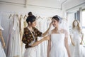 Small Business of Asian women Fashion Designer Working With Wedding Dresses at clothing store Royalty Free Stock Photo