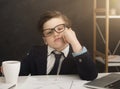 Small business boy got bored in office Royalty Free Stock Photo