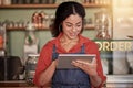 Small business, cafe barista and woman with tablet to manage orders, inventory and stock check. Coffee shop waiter Royalty Free Stock Photo