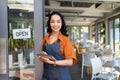 Small business entrepreneur at cafe entrance using digital tablet Royalty Free Stock Photo