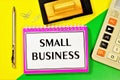 Small business-entrepreneurship of small firms. On the table is a calculator, a Commerce planning notebook, a pen for writing, and