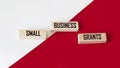Small business grant symbol. Conceptual words Small Business Grant on wooden blocks on a beautiful red and white background. The Royalty Free Stock Photo