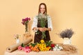 Small business market. Assorted floral arrangements. Organic plant workshop. Delicate floral decorations. Smiling woman florist in Royalty Free Stock Photo