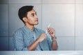 Small Business and Own Proprietor Concept. Young Asian Businessman Sitting at Modern Loft Workplace in Casual Dress