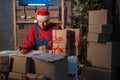 Small business owner delivery service and working packing box on Christmas, business owner santa working checking order