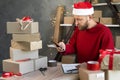 Small business owner entrepreneur works in the New Year& x27;s home office with boxes makes a photo on the phone with