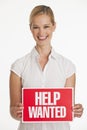 Small business owner holding up Help Wanted sign Royalty Free Stock Photo