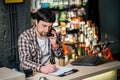 Small business owner on phone and computer in store. Sport shop worker making call with cell phone. Salesman working and talking Royalty Free Stock Photo