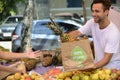 Small business owner selling organic fruits.