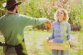 Small business owner selling organic fruits and vegetables. Two people walking in agricultural field. Earth day. Royalty Free Stock Photo