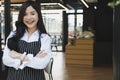 Small business owner standing with arms crossed at coffee shop. Royalty Free Stock Photo