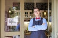 Small business owner standing in the cafe entrance with open sign while wating for guest Royalty Free Stock Photo