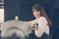 Small business owner standing at counter in coffee shop. female Royalty Free Stock Photo