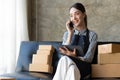 Small business owner taking orders online in front of laptop computer Female operator talking to customers or on the Royalty Free Stock Photo