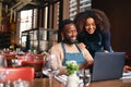 Small business owners using laptop in restaurant