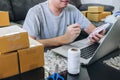 Small business parcel for shipment to client at home, Young entrepreneur SME freelance man working with note packaging sort box Royalty Free Stock Photo