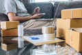 Small business parcel for shipment to client at home, Young entrepreneur SME freelance man working with note packaging sort box Royalty Free Stock Photo