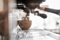 Small business, people and service concept. Bartender in apron with holder and tamper preparing coffee at coffee shop