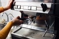 Small business, people and service concept - woman or waiter in apron with holder and tamper preparing coffee at coffee