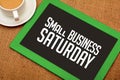 Small Business Saturday design on chalkboard with tea cup Royalty Free Stock Photo