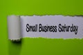 Small Business Saturday write on white and green torn paper