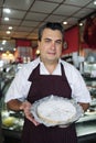 Small business: waiter showing a tasty cake