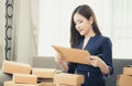 Small business woman preparing to send out her product in boxes Royalty Free Stock Photo