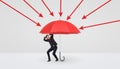 A small businessman hiding under a large red umbrella that protects him from red arrows. Royalty Free Stock Photo