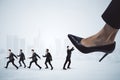 Small businessmen under big heel on background. Chief pressure, Stress at workplace concept Royalty Free Stock Photo