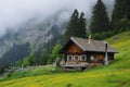 A small cabin sits nestled amidst the rugged mountains, providing a cozy retreat in a remote location, A quaint Swiss chalet in Royalty Free Stock Photo