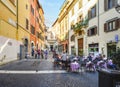 A small cafe with outdoor seating in historic Rome Italy