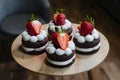 Small cakes topped with chocolate frosting and strawberries, complimentary Royalty Free Stock Photo