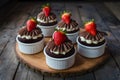 Small cakes topped with chocolate frosting and strawberries, complimentary Royalty Free Stock Photo