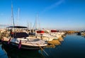 Small and calm yacht port with several bright yachts