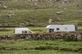 Small camper van and motor home parked by a mountains,