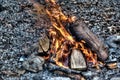 Small campfire with gentle flames in the daylight - perfect for wallpaper