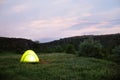 Small camping tent glowing outdoors Royalty Free Stock Photo