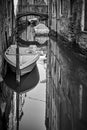 Small canal in Venice with bridge and moored boats Royalty Free Stock Photo