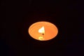 A small candle is burning in the dark Royalty Free Stock Photo