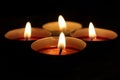 Small candles burning flames on black background Royalty Free Stock Photo