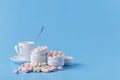 Small candy marshmallow in rosette on blue background Royalty Free Stock Photo