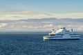 The small car ferry runs between Virtsu harbour Estonia and Saaremaa Island on Baltic Sea. Calm sea and blue sky with white clouds Royalty Free Stock Photo