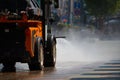 A small car pours water on the sidewalk. Royalty Free Stock Photo